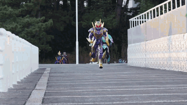 a person in a purple and gold outfit is running down a ramp