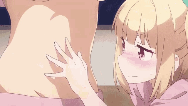 a girl is touching the back of a man 's stomach