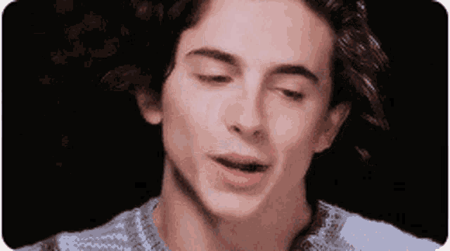 a close up of a man 's face with his eyes closed and his mouth open .