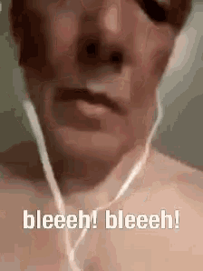 a close up of a man wearing headphones with the words bleeh ! bleeh ! written on it .