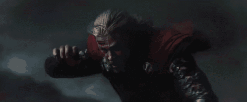 a close up of a person in a dark room with a red light coming out of their chest .