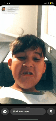 a phone screen shows a picture of a young boy with the time 21:43 on it