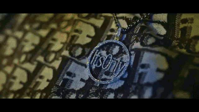a close up of a necklace with the word `` it 's only '' on it