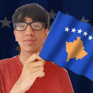 a man wearing glasses is holding a blue flag with yellow stars