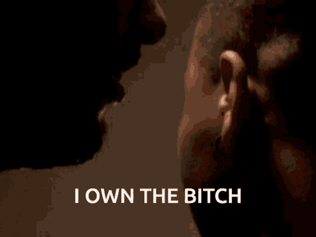 a close up of a man 's ear with the words i own the bitch above it