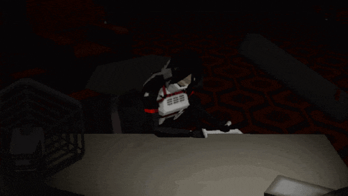 a person sitting in a dark room holding a telephone with the number 666 on it
