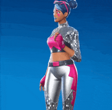 a woman is wearing a crop top with a pink star on it and silver pants and gloves .