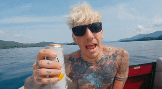 a man on a boat holding a can that says ' a ' on it