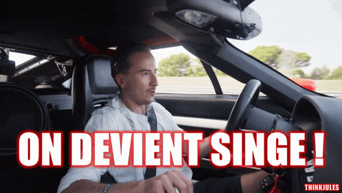 a man driving a car with the words on devient singe written on the bottom