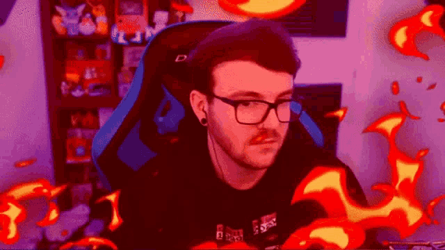 a man wearing glasses and headphones is sitting in a chair with fire coming out of his back .