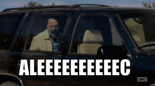 a man sitting in a car with the words aleeeeeeec on the side