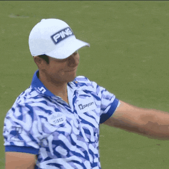 a man wearing a white ping hat and a blue and white striped shirt