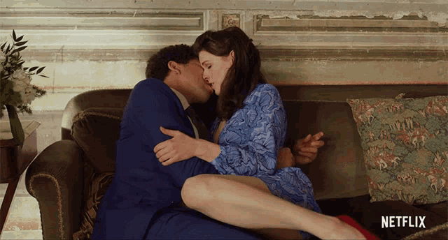 a man and a woman kissing on a couch with a netflix logo in the corner
