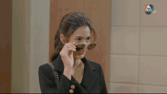 a woman wearing a pair of sunglasses with the number 7 on the bottom right
