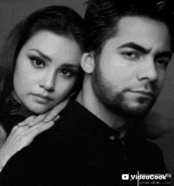 a black and white photo of a man and a woman .