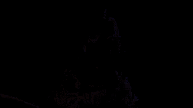 a man with a robot arm is standing in front of a power tower .