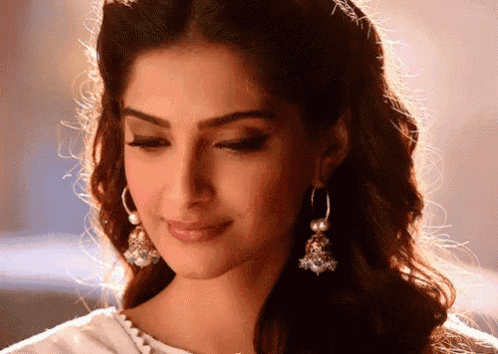 a close up of a woman wearing earrings