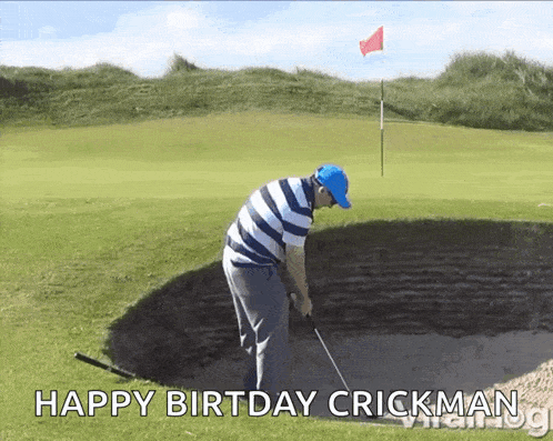 a man in a blue hat is hitting a golf ball from a bunker