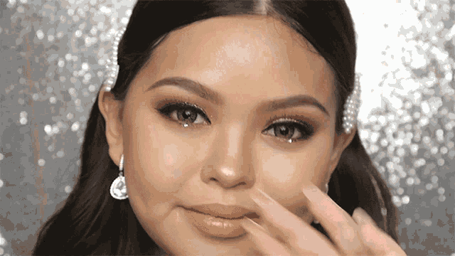 a close up of a woman 's face wearing earrings