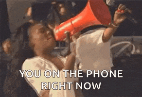 a woman is holding a megaphone in front of her face and shouting into it .