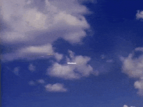 a blue sky with white clouds and the words welcome to windows on the bottom