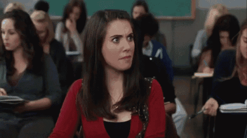 a woman sitting in a classroom with the word excuse written on her face