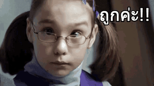 a young girl wearing glasses and a ponytail is making a face .