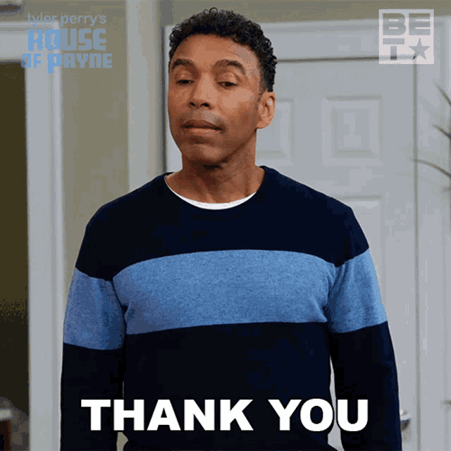 a man in a blue and black striped sweater says " thank you "