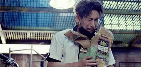 a man is holding a bag of chips and crying .