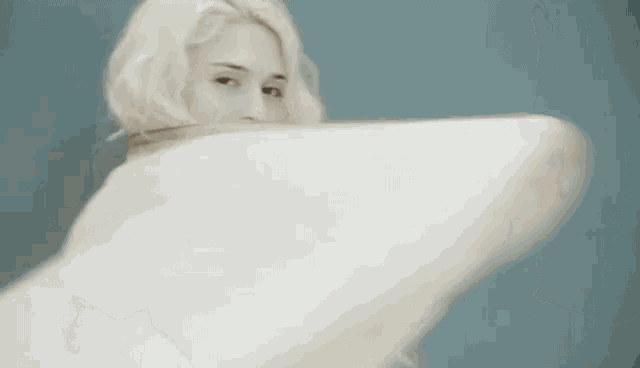 a close up of a woman 's face with white hair