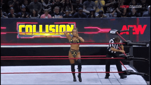 a woman in a bikini is in a wrestling ring with a sign that says collision in the background
