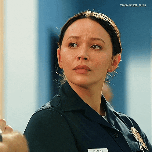a woman in a police uniform has a name tag that says chen on it