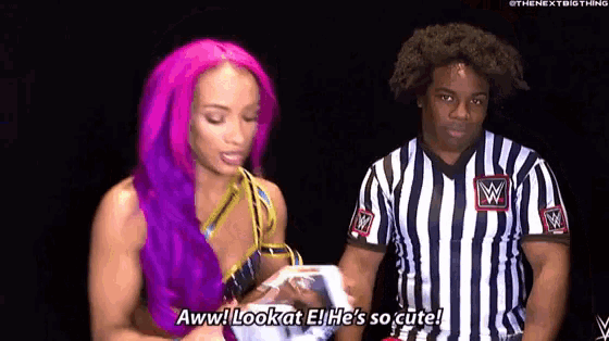 a woman with purple hair is standing next to a referee wearing a striped shirt .