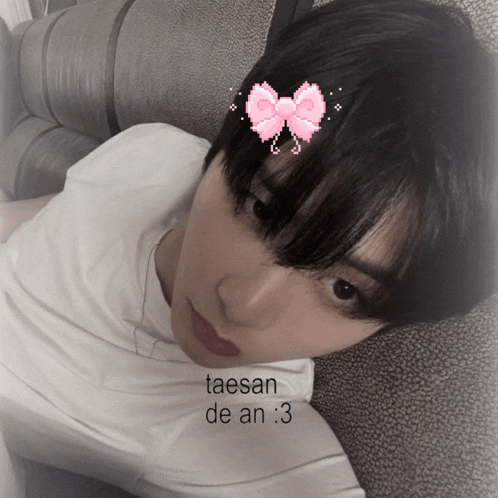 a person with a pink bow on their head has taesan de an 3 written on the bottom