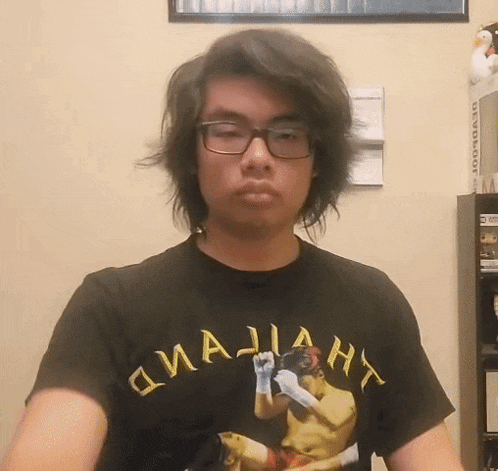 a young man wearing glasses and a t-shirt that says ' o'majian ' on it