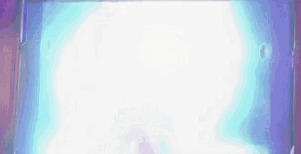 a person is standing in front of a screen with a light coming out of it .