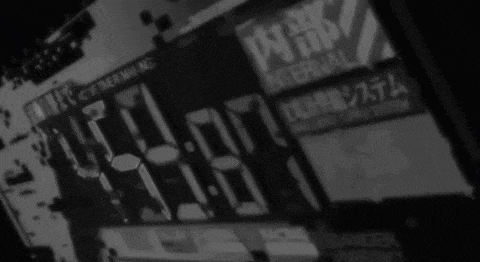 a black and white photo of a digital clock with chinese writing .