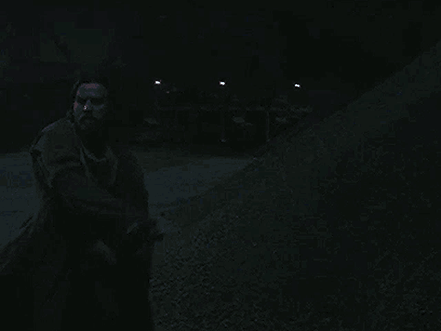 a man is holding a blue lightsaber in a dark room .