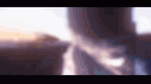 a blurry picture of a person 's face with a purple and white background