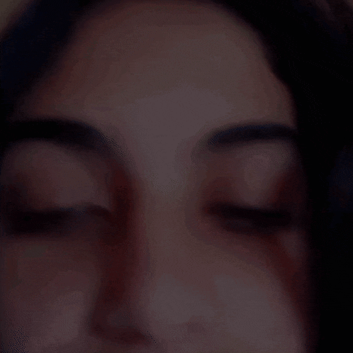 a woman 's face is shown with her eyes closed