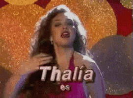 a woman in a pink dress with the name thalia on her face