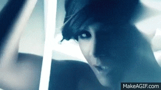 a close up of a woman 's face in a dark room .