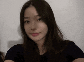 a close up of a woman 's face with long hair against a white background .
