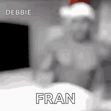 a black and white photo of a man wearing a santa hat and the word fran .
