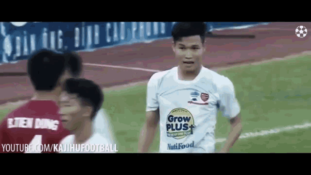 a soccer player wearing a white shirt that says grow plus nutrifood