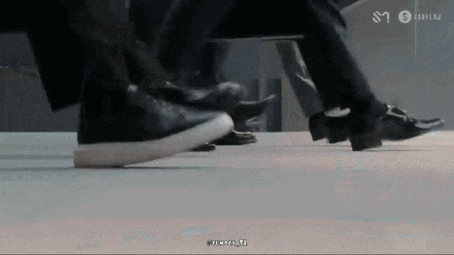 a close up of a person 's feet with the letters sn on the bottom right