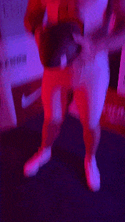a blurry picture of a person holding a football in a dark room .