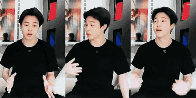 a young man wearing a black t-shirt with a chanel logo on it .