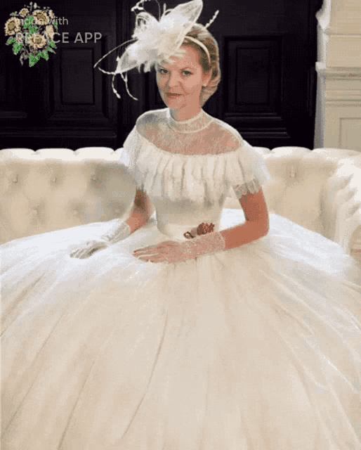 a woman in a white dress is sitting on a couch