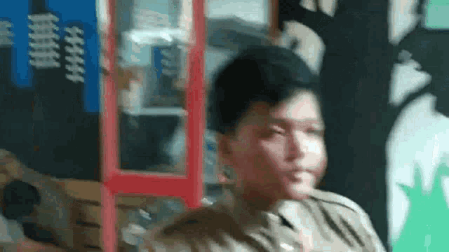 a man in a military uniform is looking at the camera .